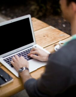 man in front of laptop computer in shallow focus photography